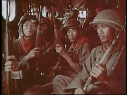 South Vietnamese soldiers hold their rifles while they sit in a helicopter. News Clip
