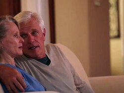 MS Senior couple watching television on couch in home living room / Richmond, Virginia, United Sates Stock Footage