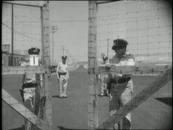 Two guards close the gates to an atomic plant in Oak Ridge, Tennessee. News Clip