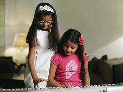 MS PAN Girls playing electric piano / India Stock Footage