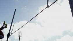 Female pole vaulter jumps and clears bar Stock Footage