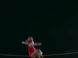 MS Shot of tightrope walker doing acrobatics on high wire at night / Gyeonggido, South Korea Stock Footage