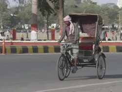 WS PAN Cycle rickshaw on city road / Patna, Bihar, India Stock Footage