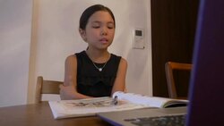 Japanese girl aged 9 years using laptop for online study English Stock Footage