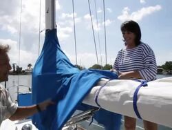 CU couple replacing sail cover on yacht /tampa,florida,USA Stock Footage