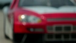 Stock-car driver pulls into pit-road, pit-crew leaps into action Stock Footage