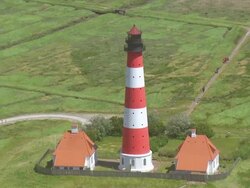 WS AERIAL DS ZI ZO Shot of Westerhever Leuchtturm / Sankt Pete Ording, Schleswig Holstein Stock Footage