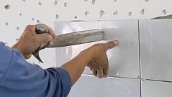 Installing Wall Tile. Stock Footage