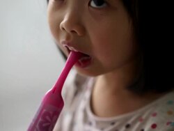 Asian female child enjoying her tooth brushing routine Stock Footage