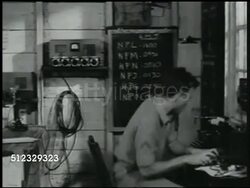 1941: U.S. MARINE BASE: COMMUNICATIONS: LA XWS Japanese bomber airplanes (unidentifiable) flying. MS Radio tower. REPRISAL: INT VS US Radioman on telephone '...Japs attacking Pearl Harbor.' EXT LA XWS Bomber airplanes. Philippines, Pacific Front, WWII Instructional Video