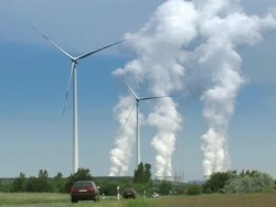 cars passing a field with wind turbines Stock Footage