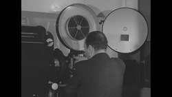 Man running film projector at film production company Pathe in NY City News Clip