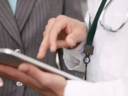  TD Doctor and businesswoman studying electronic tablet and talking / Seattle, Washington, United States Stock Footage