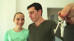 HD: Happy smiling young couple showing a keys of their new house Stock Footage