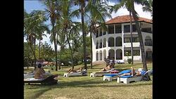 Tourists by pool and doing water aerobics News Clip