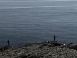 People fishing by the coast. Stock Footage