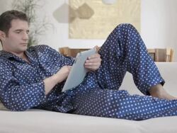 HD DOLLY: Man In Pajama Using A Digital Tablet Stock Footage