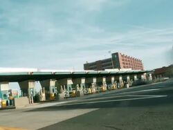 Time lapse, toll booth exits, multiple cars and traffic drive away down the interstate highway. Stock Footage