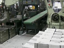 MS Newspapers piled up by machines in gravure printing office / Itzehoe, Schleswig-Holstein, Germany  Stock Footage