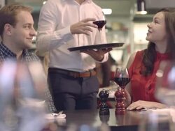 MS PAN Man and woman in restaurant, waiter serving wine Stock Footage