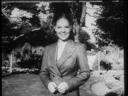 B/W 1937 PORTRAIT Alice Faye standing outdoors waving / documentary Stock Footage