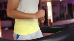 Young man running on treadmill Stock Footage