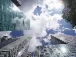WS T/L PAN Shot of sun and moving clouds above skyscraper at 42nd street / New York, United States Stock Footage
