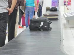 Baggage conveyor belt in the airport carrying the passenger luggage Stock Footage