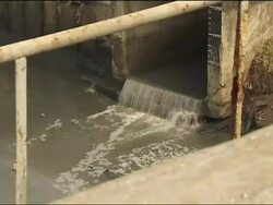 Polluted canal alongside Mumbai slum Stock Footage