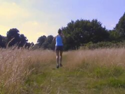 Rear view of a woman running; UK Stock Footage