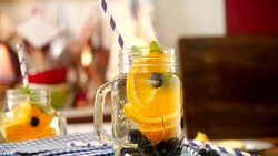 Infused Water with Fresh Blueberries and Oranges Stock Footage