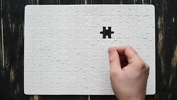 male hand adds white puzzle Stock Footage