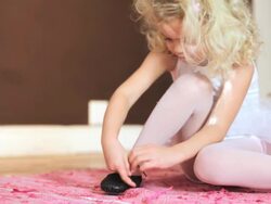 Young girl tying her shoelace Stock Footage