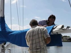 couple removing sail cover on yacht /tampa,florida,USA Stock Footage