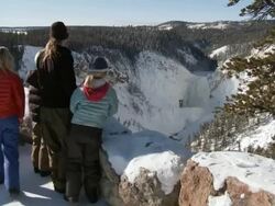 WS Some child's and woman looking snowy forest landscape with frozen waterfall / Yellowstone National Park, Wyoming, United  Stock Footage