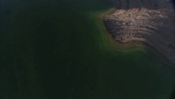 An aerial view follows the Colorado River shoreline near the Hoover Dam. Stock Footage