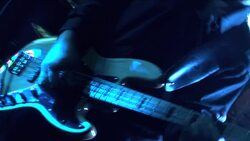 A singer and a guitarist perform in a night club as party-goers dance. Stock Footage