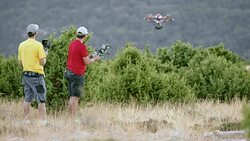 LD Two men operating a drone in the air Stock Footage