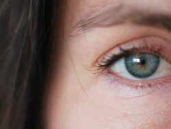 Macro Camera pans Womans Blue Eyes Stock Footage
