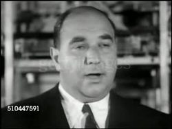 1949: AUTOMATIC GARAGE: CU Report 'Automatic Garage.' REPRISAL: VS William Zeckendorf speaking w/ reporters '...the answer to city parking lies in tall multi-story garages for mass parking of automobiles handled by remote control...' Instructional Video