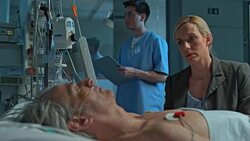 DS Wife sitting by sleeping husband in ICU at night Stock Footage