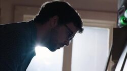 Shop worker hangs price tags on new skateboards and catalogs info on laptop computer Stock Footage