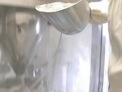 Closeup tilt shot of person scooping powder into a funnel. Stock Footage