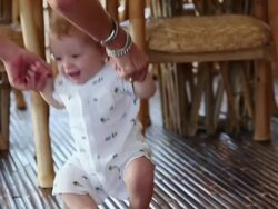 MS TS Shot of mother holding her baby to stand up and walk / Ubud, Bali, Indonesia Stock Footage