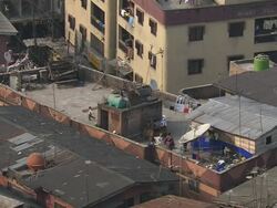 WS View of rooftop with three children running and playing / Lagos, Nigeria Stock Footage