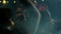 Medium dolly shot of lead guitar through party crowd Stock Footage