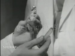 1951: TEACHING HOSPITAL: INSULIN THERAPY: * Psychiatrist holding insulin bottle & hypodermic needle in hands, CU bottle & needle, demonstrating where to administer shot on patient as female rolls onto side. Instructional Video