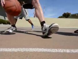 DS TS Dolly of male basketball players dribbling the basketball. Stock Footage