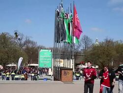 Long shot of club flags and fans arriving at Stock Footage
