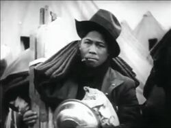 B/W 1932 PORTRAIT Black WWI veteran smoking cigarette holding blanket + cot / Bonus March Stock Footage